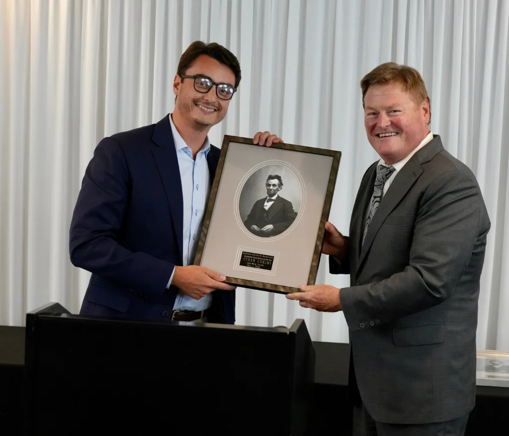 Ethan Carlos being presented the SCBA 2026 Outstanding Young Lawyers of the Year